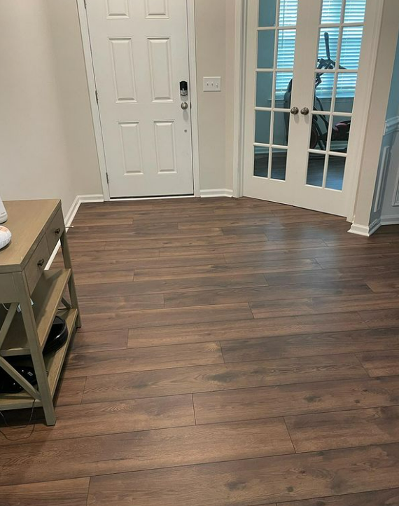 an image of dark brown laminate flooring in the hallway of a modern home