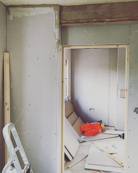 an image of a doorway with plasterboard walls 