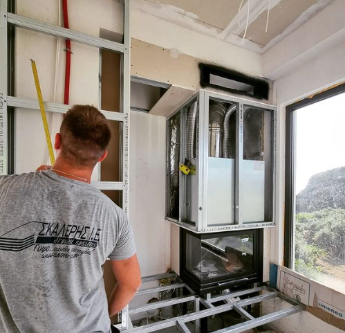 an image of a man painting plasterboard in home