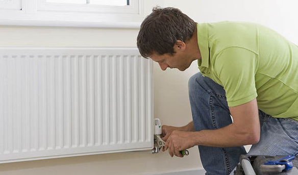 an image of a person completing the bleeding of the radiator