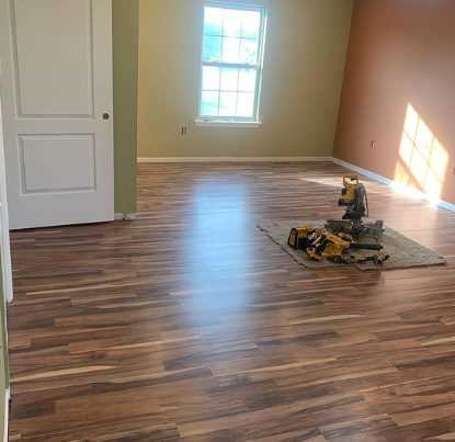 an image of a dark brown laminate flooring in beige room with LEGO on floor