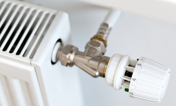 an image of a the radiator valve of a bright white radiator