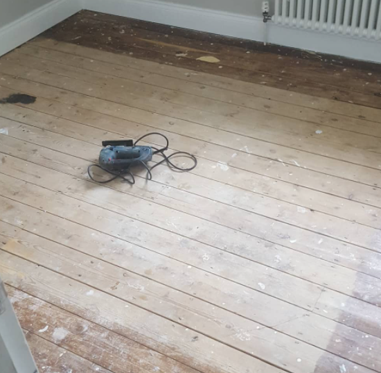 an image of a stripped floor with no laminate flooring applied