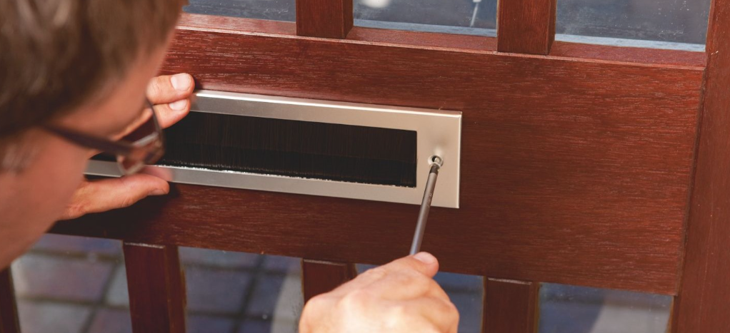 an image of a man securing letterbox for daughts