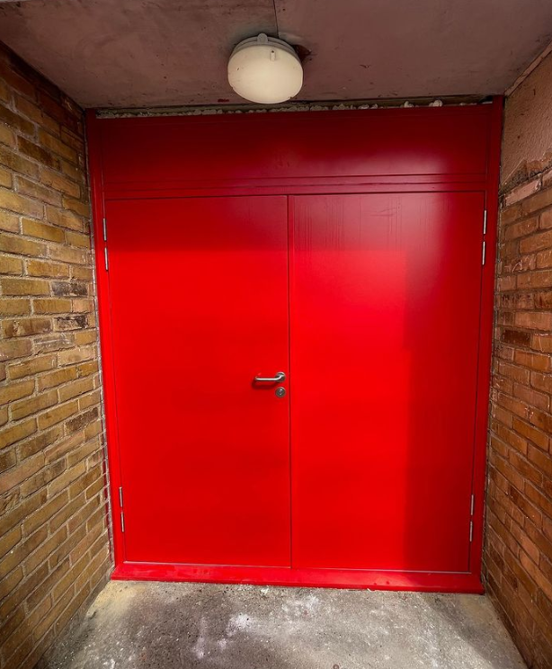 an image of a bright red fire door and red bricks