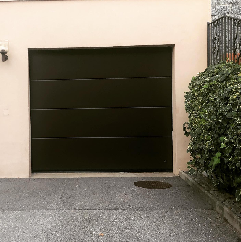 an image of a slate black garage door on a white wall