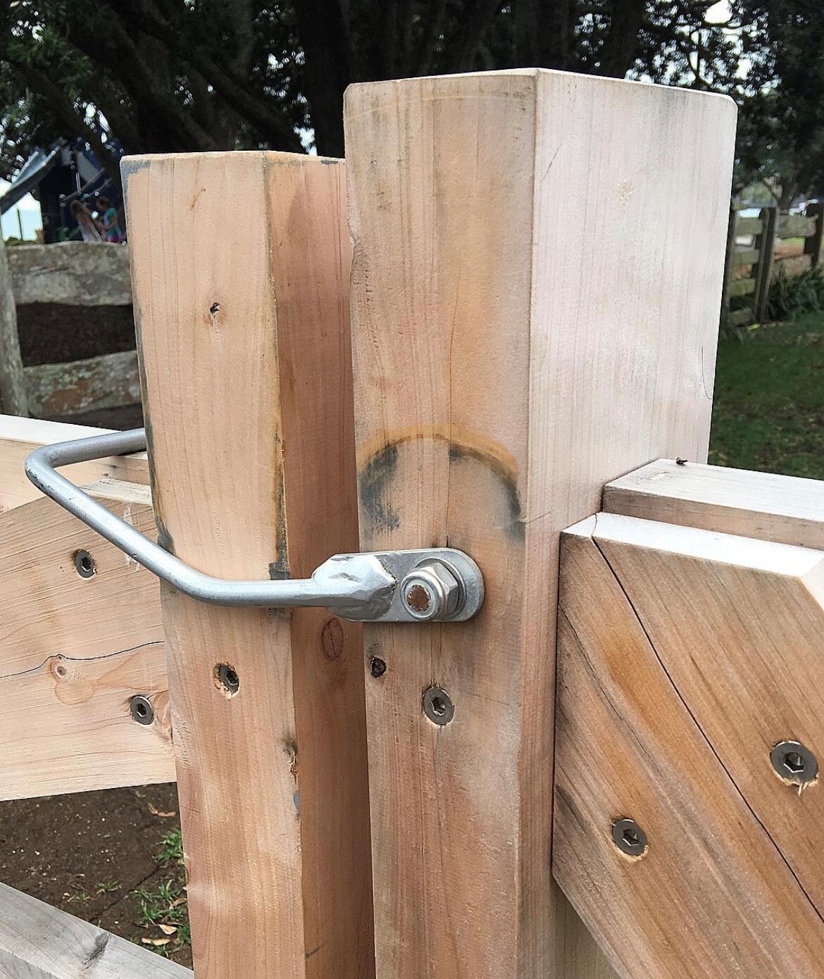 an image of a wooden gate with a metal latch