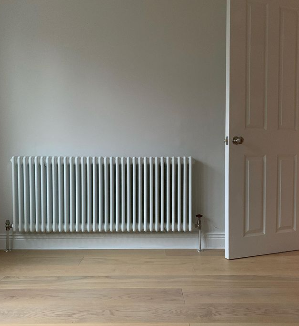 an image of a white radiator with a white door and scotia beading