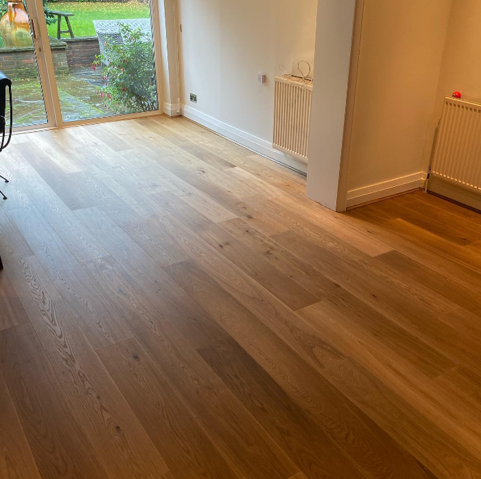 an image of a wooden floor in home with white scotia beading