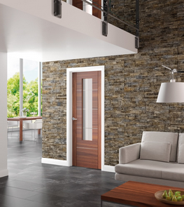 An image showing Portici Pre-Finished Internal Walnut Door Clear Glass set in a open space living room with white sofa and coffee table.