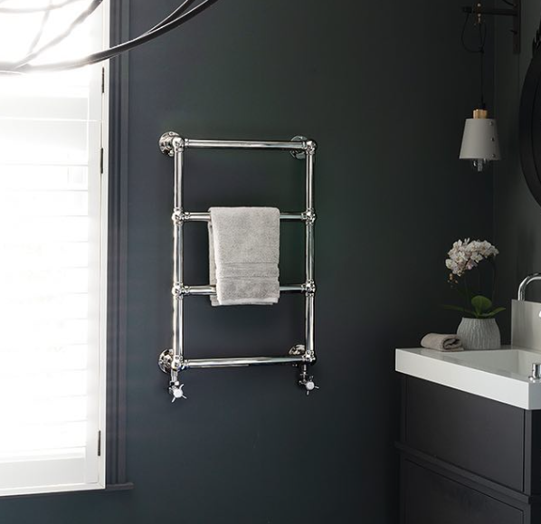 an image of a traditional stainless steel towel rail in a room.