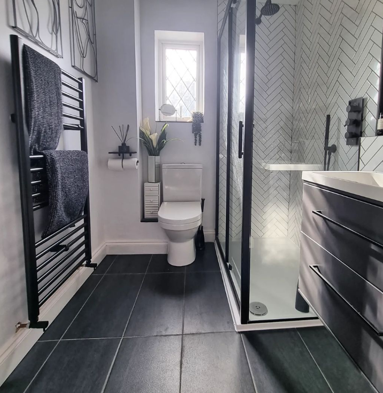 an image of a black towel rail in a modern black bathroom
