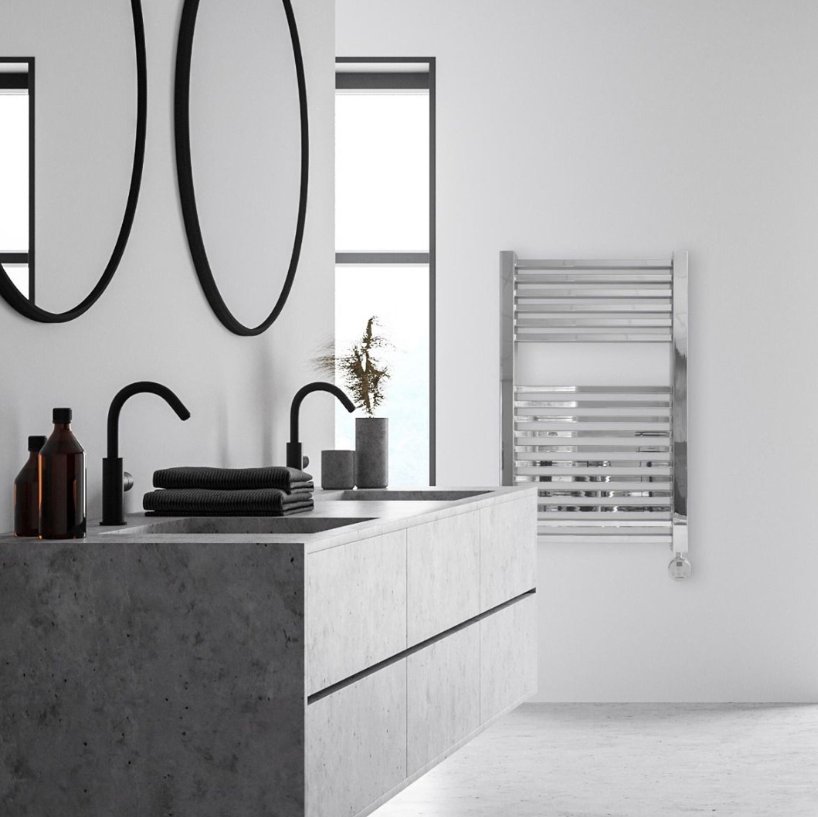 an image of a white bathroom with chrome towel rail. Black mirrors and accessories 