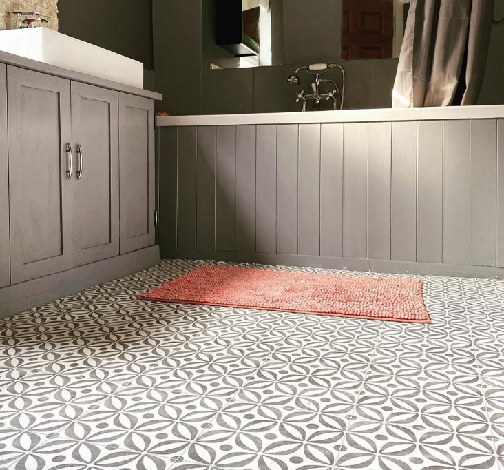 an image of vinyl flooring in a modern grey bathroom with a pink bath mat